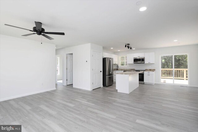 4205 Cabin Creek Hurlock Rd, Hurlock, MD 21643 - unfurnished living room with light wood-style floors, baseboards, recessed lighting, and a sink