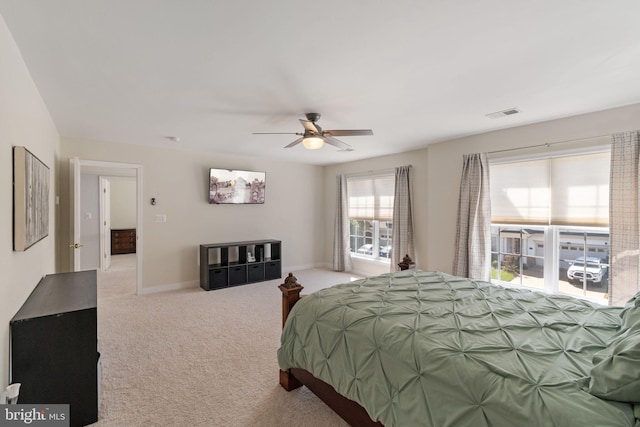 carpeted bedroom featuring visible vents, a ceiling fan, and baseboards
