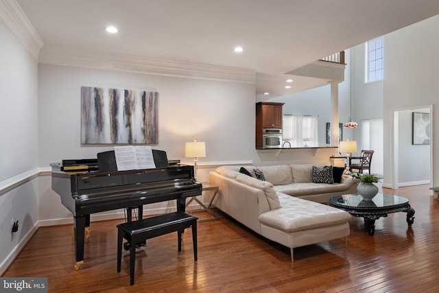 living room with crown molding, recessed lighting, wood-type flooring, and baseboards
