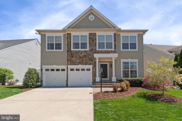 view of front of home featuring a garage, a front yard, stone siding, and concrete driveway