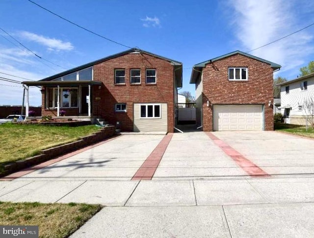 view of front of house featuring a garage, concrete driveway, a front lawn, and brick siding
