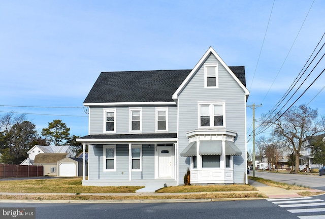 25 E High St, Felton, DE 19943 - view of front facade with a porch, roof with shingles, and an outdoor structure