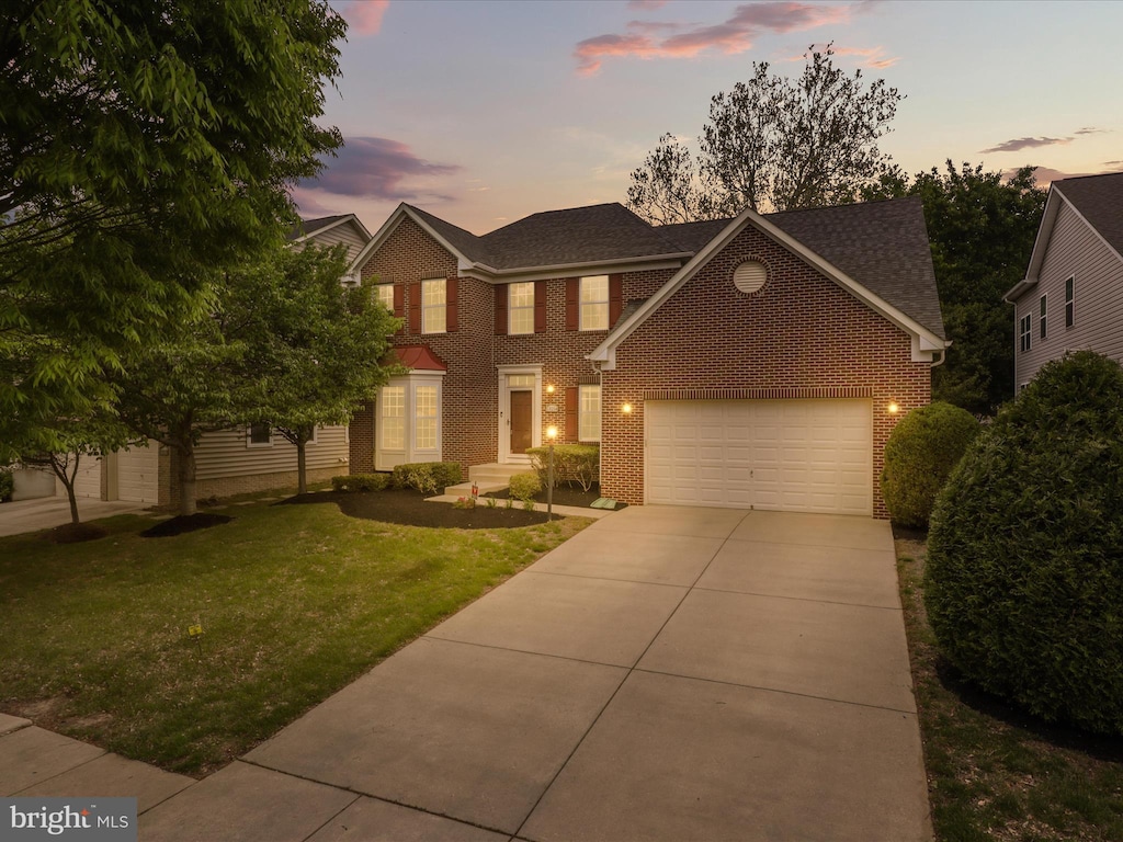 13214 Eldorado Greenfields Dr, Bowie, MD 20720 - view of front facade featuring a shingled roof, an attached garage, brick siding, concrete driveway, and a yard