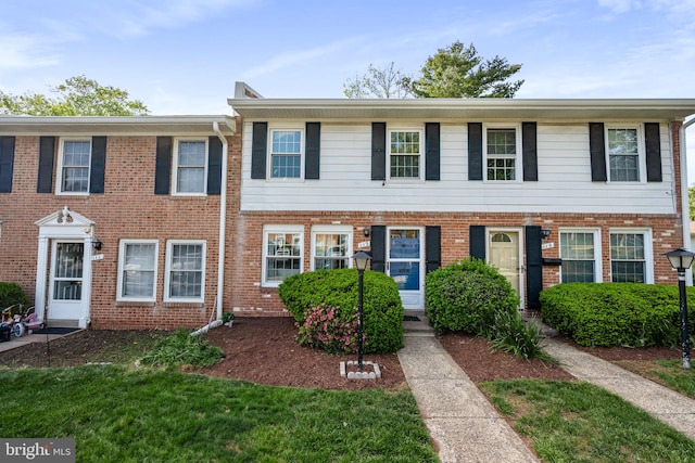 townhome / multi-family property with brick siding