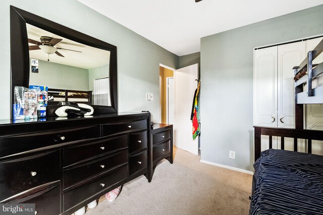 bedroom with baseboards, ceiling fan, and light carpet