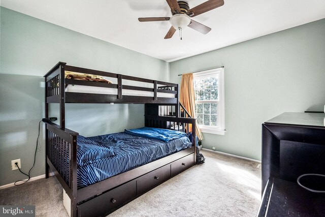 bedroom with baseboards, ceiling fan, and carpet