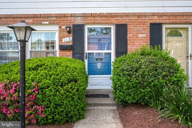 property entrance with brick siding