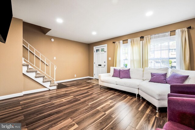 living area featuring recessed lighting, baseboards, dark wood-style floors, and stairs