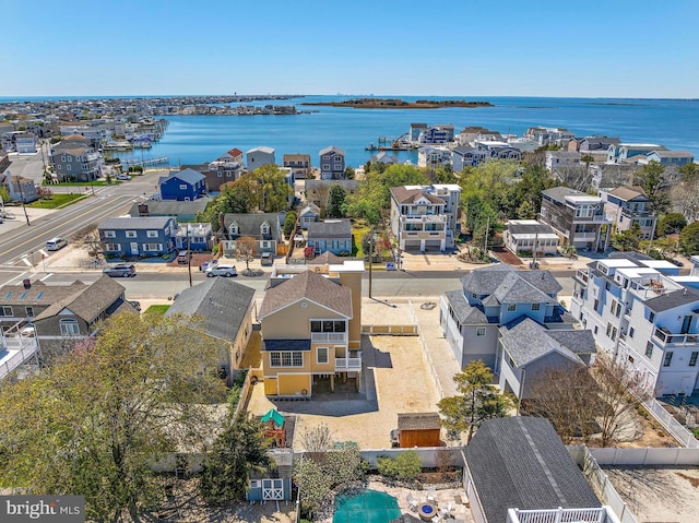 birds eye view of property featuring a residential view and a water view