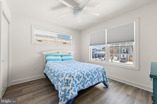 bedroom featuring baseboards, ceiling fan, and wood finished floors