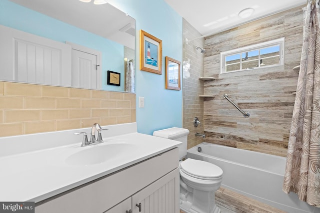 full bathroom featuring vanity, shower / tub combo with curtain, and toilet
