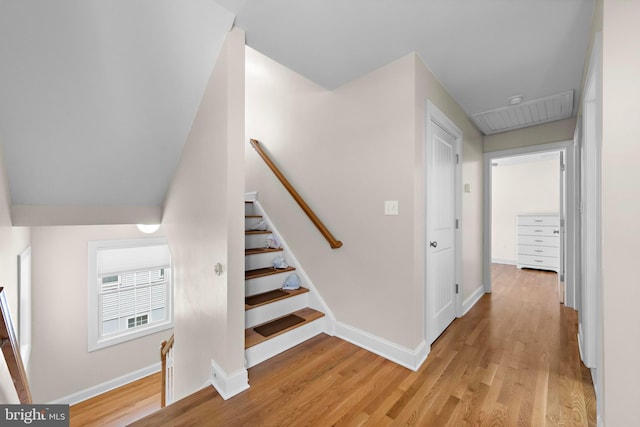 stairs with baseboards and wood finished floors