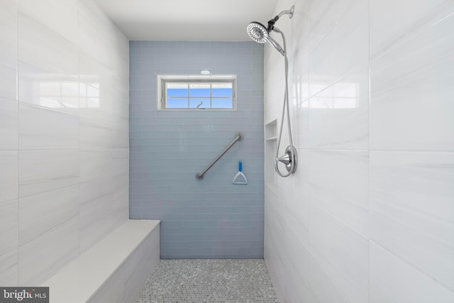 full bath with tile walls and tiled shower