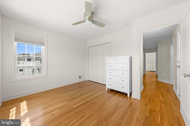 unfurnished bedroom featuring a closet, baseboards, visible vents, and light wood-type flooring