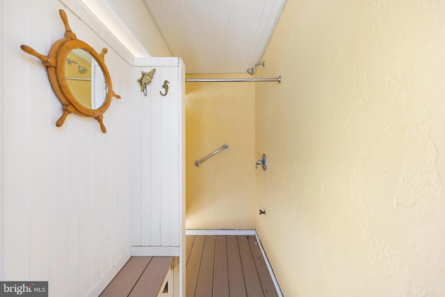 washroom with baseboards and wood finished floors
