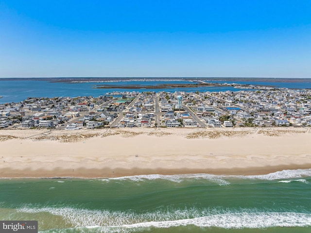 drone / aerial view featuring a water view and a view of the beach