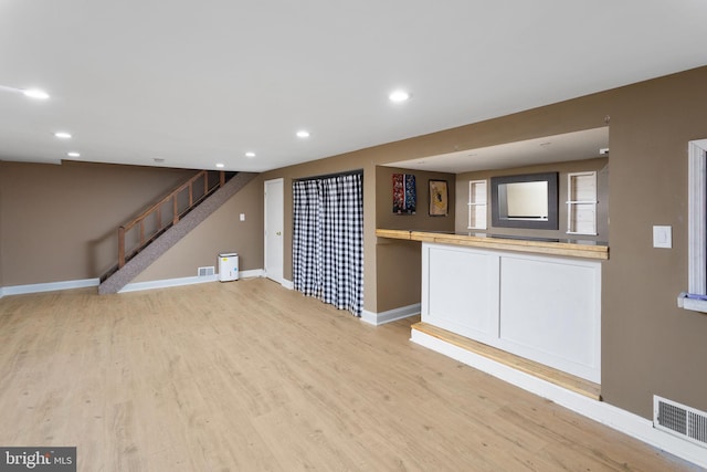 interior space with visible vents, baseboards, light wood-style flooring, and recessed lighting