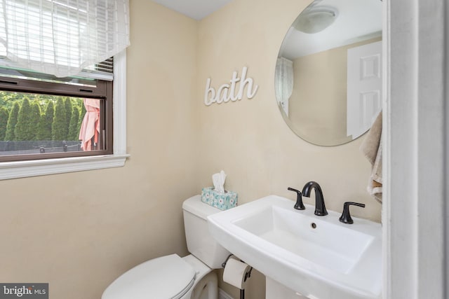 bathroom with toilet and a sink