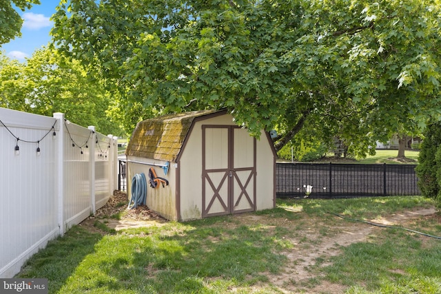 view of shed featuring fence