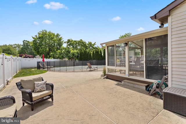 view of patio with a fenced backyard, a sunroom, and a pool