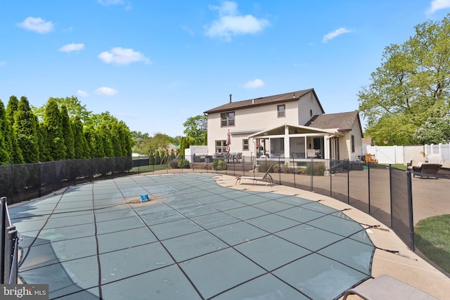 view of pool with a patio area and fence