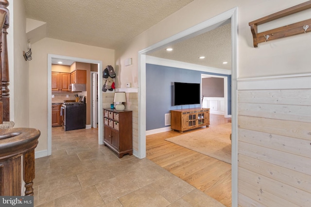 interior space with baseboards, visible vents, and a textured ceiling