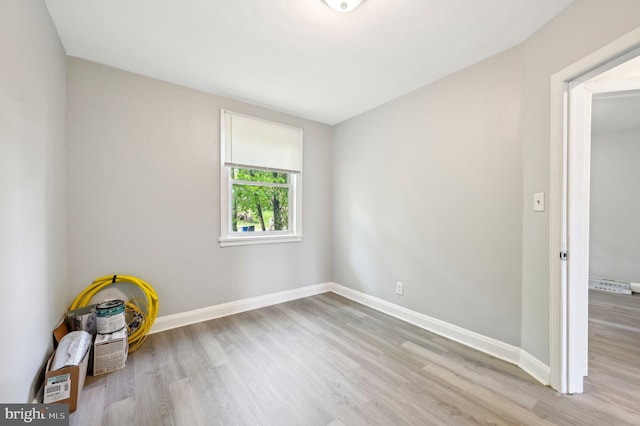 interior space featuring baseboards and wood finished floors