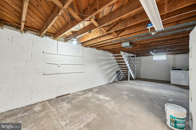 basement with stairs and washer and dryer