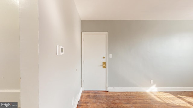 interior space featuring baseboards and wood finished floors