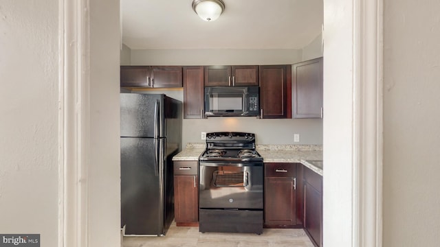 kitchen featuring light wood-style floors, black appliances, and dark brown cabinets