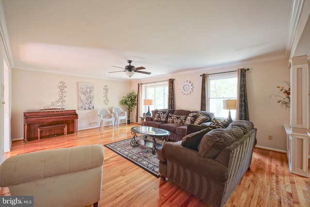 living room with baseboards, a ceiling fan, light wood-style flooring, and ornamental molding