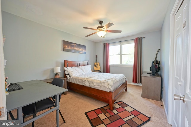 bedroom featuring a ceiling fan and light colored carpet
