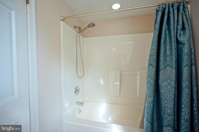 bathroom with shower / tub combo with curtain