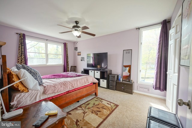 carpeted bedroom featuring baseboards and ceiling fan