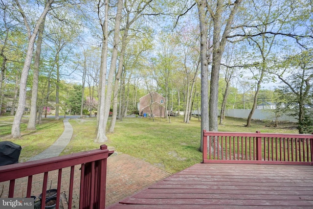 wooden terrace featuring a lawn