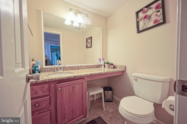 bathroom featuring vanity, tile patterned flooring, baseboards, and toilet