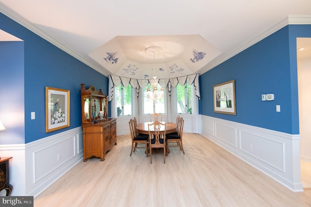 2210 Horns Point Rd, Cambridge, MD 21613 - dining space featuring a decorative wall, light wood finished floors, wainscoting, a raised ceiling, and crown molding