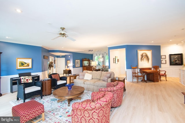 2210 Horns Point Rd, Cambridge, MD 21613 - living room featuring light wood-style flooring, ornamental molding, a decorative wall, a ceiling fan, and a wainscoted wall