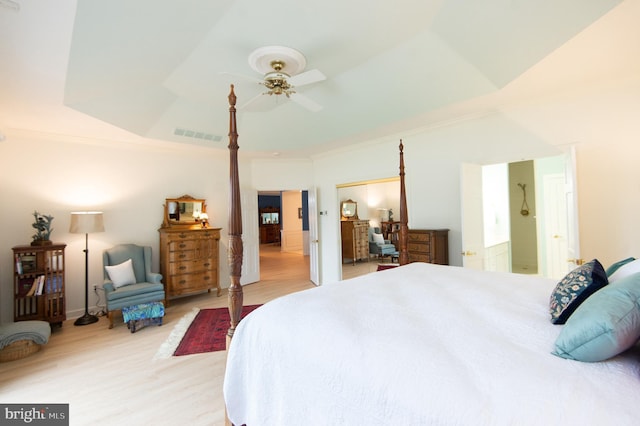2210 Horns Point Rd, Cambridge, MD 21613 - bedroom featuring light wood-type flooring, crown molding, a ceiling fan, and a tray ceiling