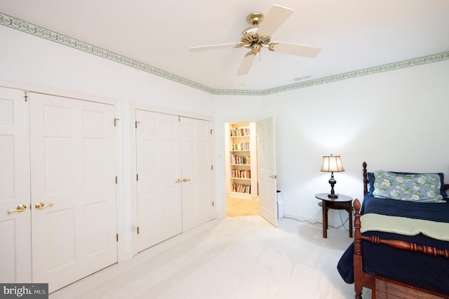 2210 Horns Point Rd, Cambridge, MD 21613 - bedroom with light colored carpet, multiple closets, baseboards, and ceiling fan