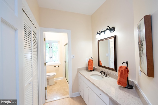 2210 Horns Point Rd, Cambridge, MD 21613 - full bathroom with toilet, a closet, vanity, a shower stall, and baseboards