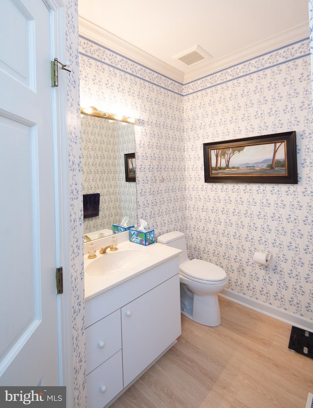 2210 Horns Point Rd, Cambridge, MD 21613 - bathroom with vanity, wood finished floors, toilet, crown molding, and wallpapered walls