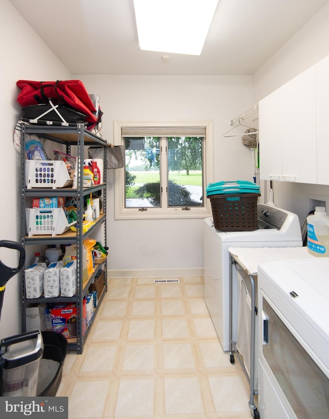 2210 Horns Point Rd, Cambridge, MD 21613 - washroom with independent washer and dryer, cabinet space, light floors, and baseboards