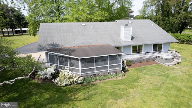 2210 Horns Point Rd, Cambridge, MD 21613 - rear view of property with a sunroom, a yard, a chimney, and a deck