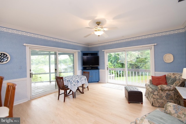 2210 Horns Point Rd, Cambridge, MD 21613 - living room with wallpapered walls, healthy amount of natural light, light wood-style flooring, a ceiling fan, and crown molding