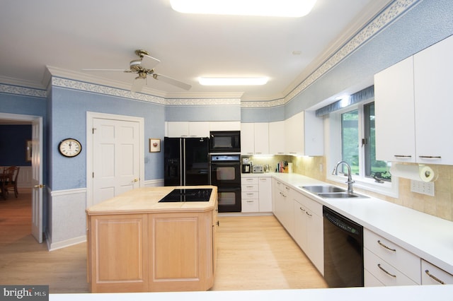 2210 Horns Point Rd, Cambridge, MD 21613 - kitchen with black appliances, a sink, light wood-style flooring, a center island, and light countertops