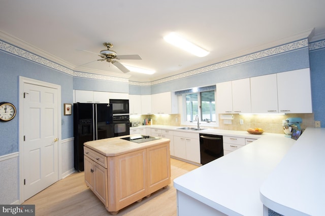 2210 Horns Point Rd, Cambridge, MD 21613 - kitchen with black appliances, a sink, light wood-type flooring, light countertops, and backsplash