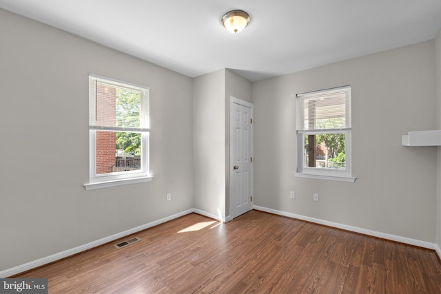 2926 Yorkway, Baltimore, MD 21222 - unfurnished room featuring wood finished floors, plenty of natural light, and baseboards
