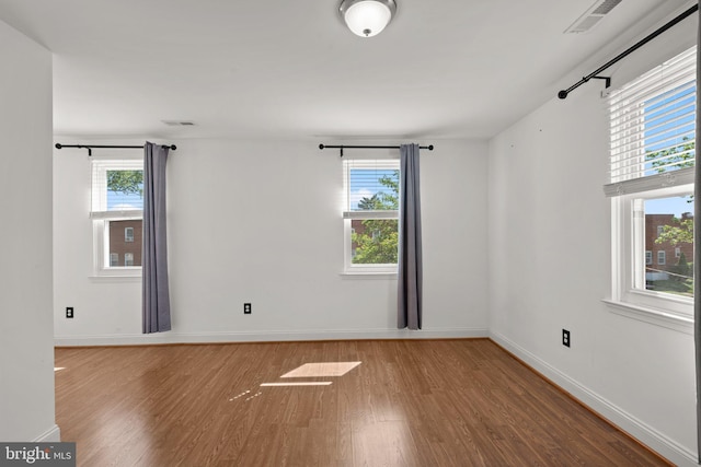 2926 Yorkway, Baltimore, MD 21222 - unfurnished room featuring wood finished floors, plenty of natural light, and baseboards