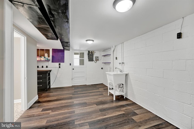 6824 Duluth Ave, Dundalk, MD 21222 - laundry area featuring dark wood-style floors and concrete block wall